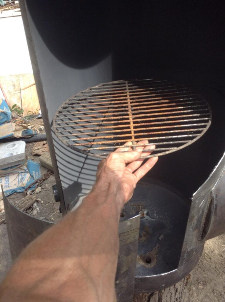 Holding a round grille from the small brinkman smoker in the vertical smoke chamber of the smoker I made. They will work just fine and they're readily available and cheap 